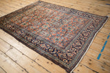 An angled view of the vintage Bibikabad rug displays the detailed unidirectional tree of life design.