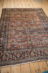 Hand-knotted Bibikabad rug showing the brick-red field and navy Turtle Samovar border from an angle.