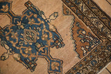 Dusty denim blue medallion with bronze accents on abrashed pale coffee brown ground and border.