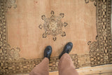 Traditional abrashed sandalwood vintage Tabriz rug with brown quatrefoil medallion and feet.