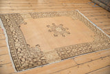 Close-up of vintage Tabriz rug's scalloped trefoil medallion and abrashed sandalwood field.