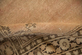 Detail of vintage Tabriz rug showing mostly even wear and coffee brown palmette motifs.