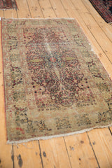 Antique Kerman rug: ornate tree of life medallion, cochineal red, ivory, jade green, and patina.