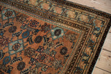 Corner detail of vintage Malayer rug with terracotta Herati pattern and sapphire blue borders.