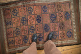 Antique Belouch rug featuring tiled arrowed guls with inverted red and blue grounds.