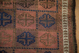 Antique Belouch rug's primitive geometric border, white pattern, and dark goat hair selvage.