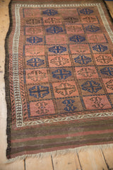 The securely finished, striped kilim end and short fringe of an antique Belouch rug.