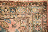 Close-up of the vintage Anatolian rug's stepped corner spandrel and floral vine border.