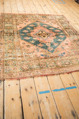 Angled perspective of a vintage Anatolian rug highlighting its lustrous wool and central medallion.
