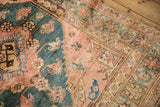 Stepped corner spandrel and floral vine border in dusty rose, teal, and saffron tones.