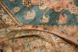 A folded vintage Anatolian rug showing its supple handle and soft, silk-like wool pile.