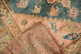 A folded corner of the vintage Anatolian rug reveals its hand-knotted foundation and wool pile.