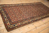 Kurdish Hamadan runner's field of madder red lattice vines with antique ivory floral borders.