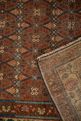Vintage Hamadan rug pile with brown lattice and checkered floral motifs, showcasing its woven back.