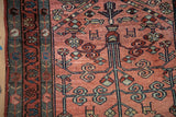 Vintage Persian Mehriban rug detail: dusty raspberry field, blue tree-of-life, vine and boteh borders.