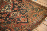 Vintage Josan Sarouk rug corner, showing madder root red vine border and characterful fringe.