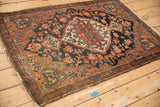 Josan Sarouk rug corner: madder red border with blue vine and dusty palmettes.