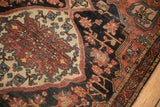 Storied vintage Josan Sarouk rug detail: red palmettes on beige corner and navy field.
