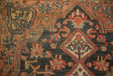 Vintage Josan Sarouk rug: diamond finial with madder red and blue blossoms on dark navy ground.
