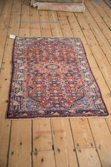 Vintage Tajabad rug from an angle, highlighting the dense Herati pattern and gem-like colors.
