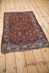 Angled view of a vintage Tajabad rug showing its intricate Herati design and gem-like colors.