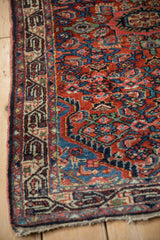 Intricate Serbend main border and dense Herati field on a vintage Persian Tajabad rug corner.