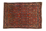 Antique Persian Bijar rug with a red Herati design field and a geometric Samovar border.