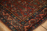 Corner detail of an antique Bijar rug showing the Samovar border and low, even pile.