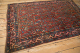 Antique Bijar rug with a Samovar border framing the dense, madder red Herati-patterned field.