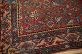 Corner detail of an antique Bijar rug showcasing the geometric Samovar border and its dense, low pile.