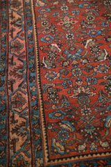 Close view of a Persian Bijar's madder red Herati field and its intricate Samovar design border.