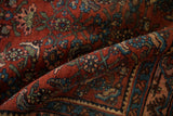 A fold highlights the Samovar border and Herati field of this antique Persian Bijar rug.