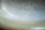Seafoam green fiberglass texture of a vintage Herman Miller chair, showing playful fibers.