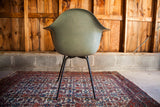 Vintage seafoam green Herman Miller chair, back view showing fiberglass texture.