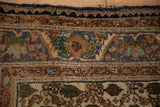 Close-up of vintage Sarouk rug's serrated floral border and field in blue, ivory, terracotta.