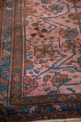 Detail of the antique Lilihan rug's expressive floral blossoms and sprawling indigo vines.