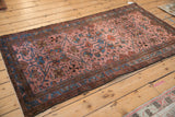 Angled view of an antique Lilihan rug highlighting the lustrous sheen of its floral vine pattern.