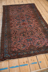 Angled perspective of a fine antique Lilihan rug showing its lustrous raspberry red pile.