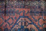 Antique Borchalou runner's madder root red field with cobalt blue geometric mahi-mahi motifs and worn pile.