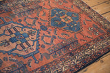 Antique Borchalou rug's madder red field and Serbend border with geometric patterns.