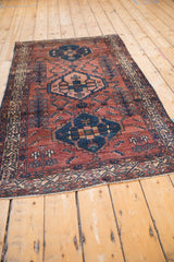 Bottom fringe of antique Borchalou rug, featuring Serbend border, repeating boteh, madder red, and cobalt blue.