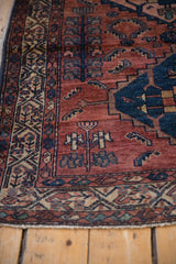 Colorful repeating boteh border, madder red field, and hand-knotted fringe of an antique Borchalou.