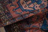Lustrous madder red and cobalt blue mahi mahi patterns on antique Borchalou rug.