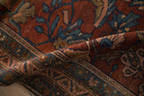 Close detail of the low pile and meandering vine border on an antique Persian Mehriban rug.