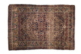 Antique Fine Kermanshah rug with oversize starburst medallion, dense floral field, and green gold border. 4'2