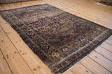 Fine antique Kermanshah rug showing intricate green gold border and blue turtle samovar motifs.