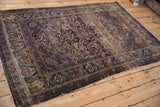 Fine Kermanshah rug border with green gold ground, turtle samovar arabesques, and worn floral field.