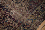 Green-gold main border and turtle samovar motifs on a worn antique Kermanshah rug.