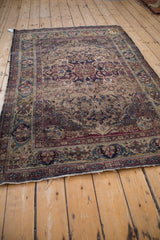 Antique Kermanshah rug with an unusual green gold border, expressive arabesques, and corner botehs.