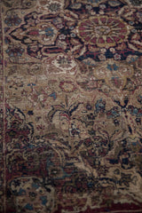 Antique Kermanshah rug showing dense floral patterns and visible foundation wear.